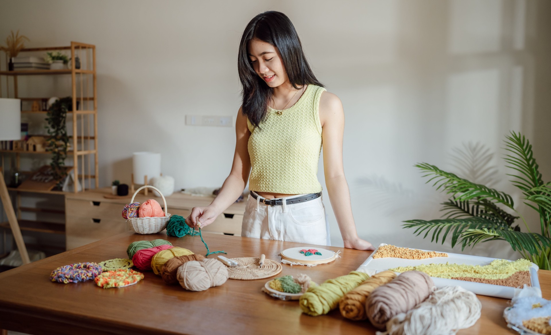 Punch needle. Asian Woman making handmade Hobby knitting in studio workshop. designer workplace Handmade craft project DIY embroidery concept.